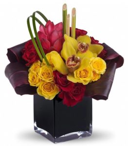 sland dreams can come true no matter where you are if you're lucky enough to receive this delightful bouquet. It beautifully combines tropical flowers with greens and hand-delivers them in a dramatic black cube vase.