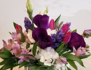a beautiful assortment of spring flowers in pinks purples and white