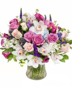 A luxurious arrangement filled with hydrangea, roses, cymbidium orchids and calla lilies. 